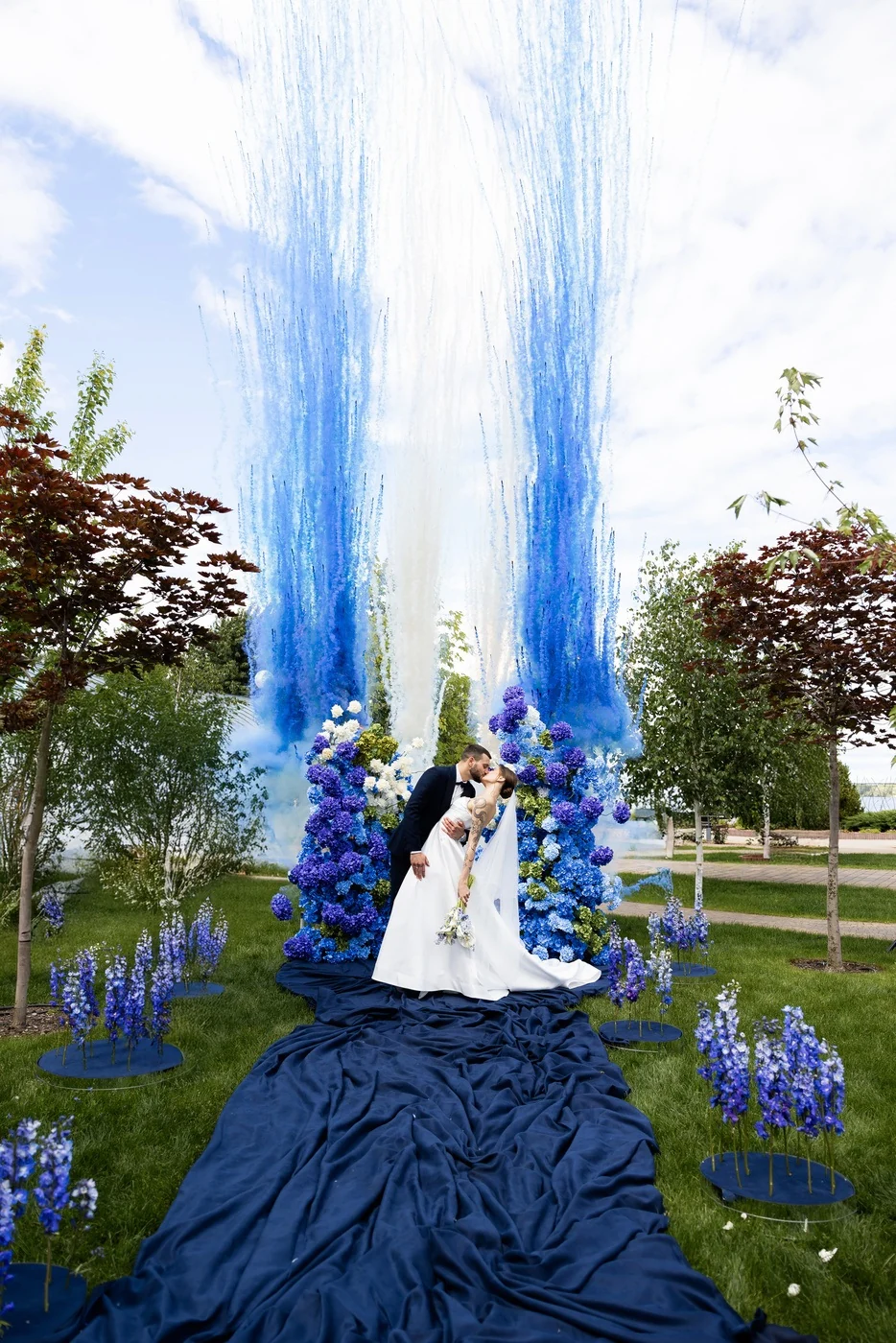 Blue coloured smoke at an outdoor celebration, presented by SHOW PLUS